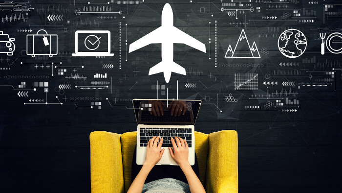 © Tierney, stock.adobe.com Flight ticket booking concept with person using a laptop in a chair
